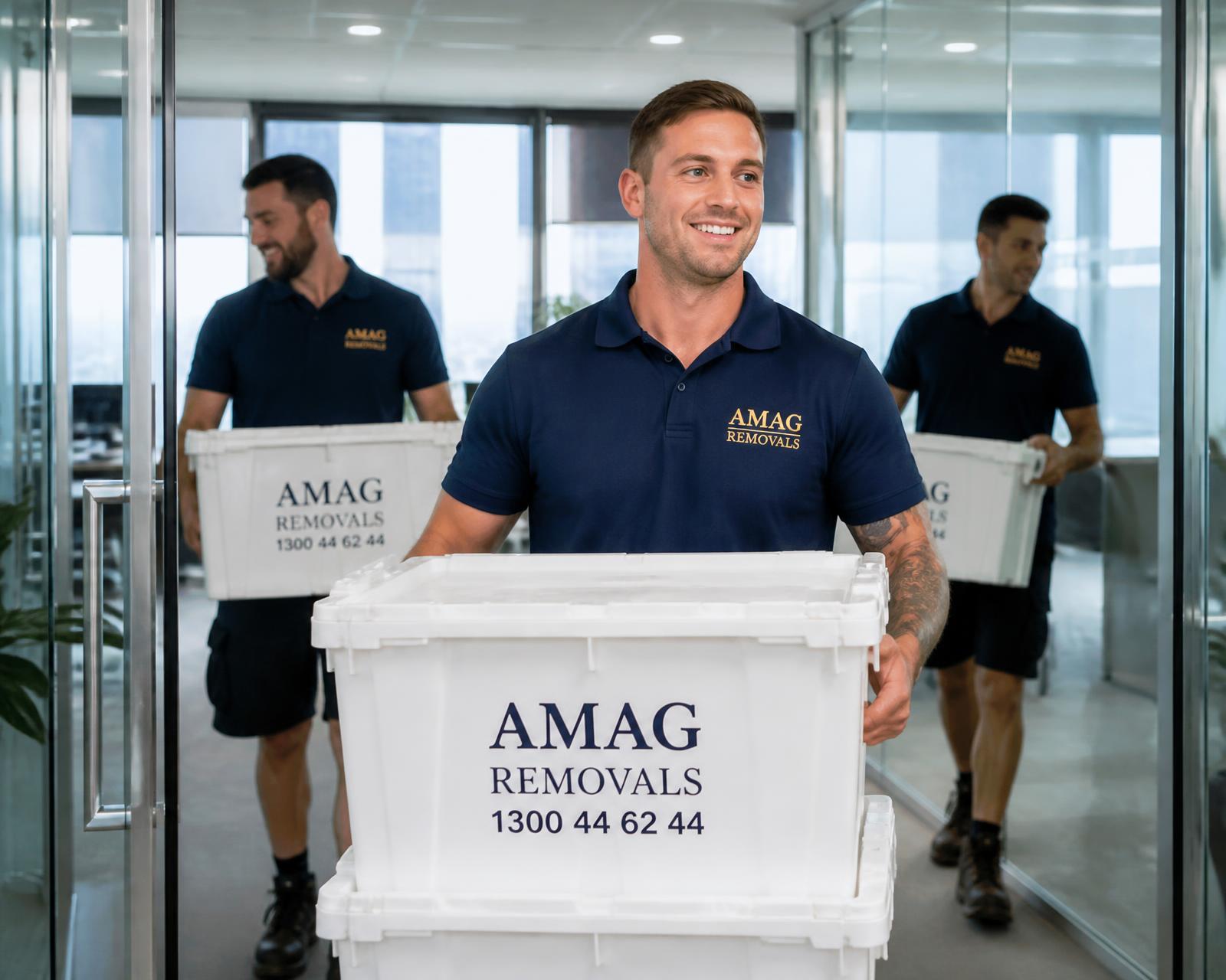 AMAG removalists carrying labelled crates through a Melbourne corporate office