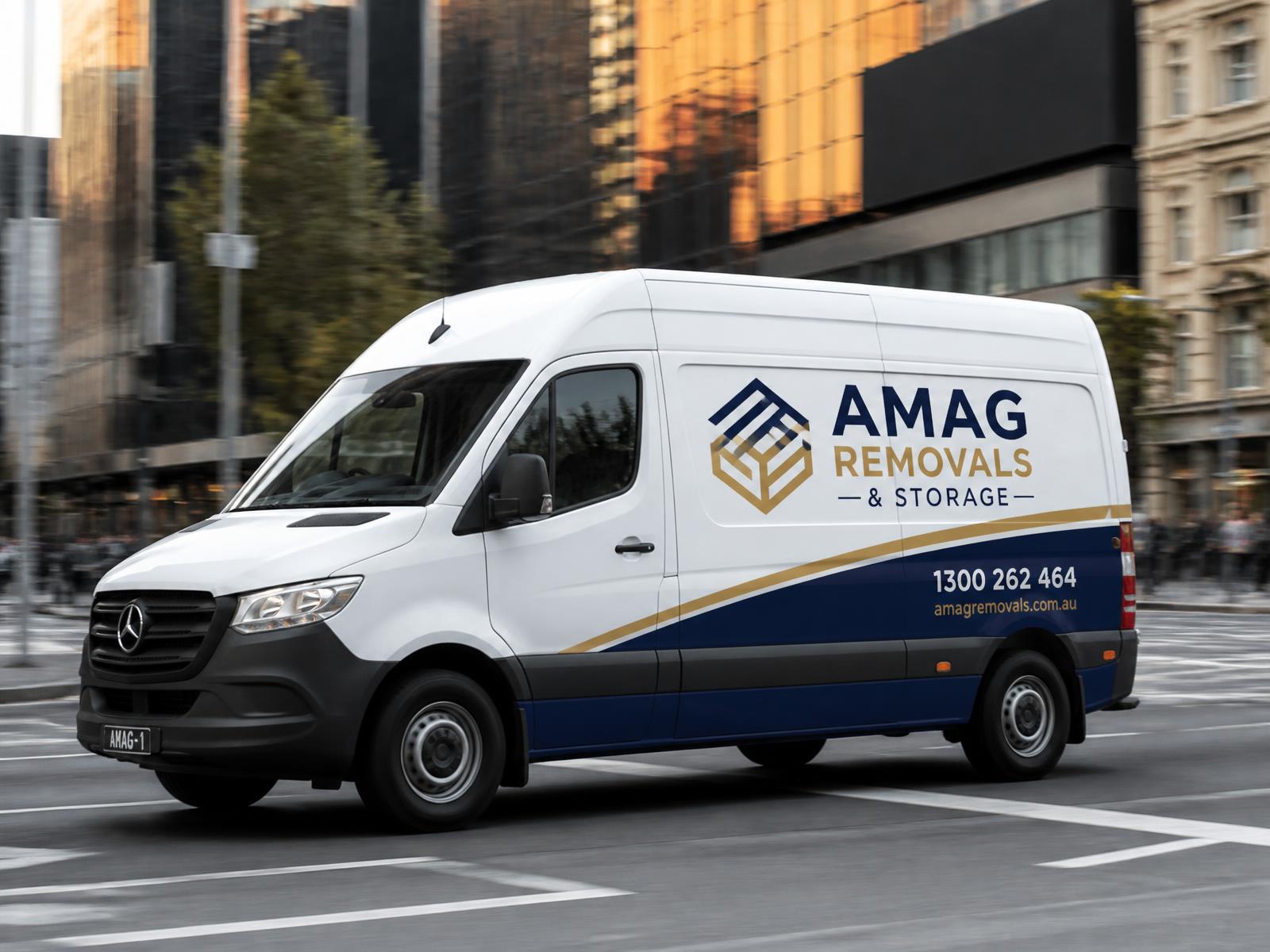 AMAG white courier van with blue-and-gold branding moving through Melbourne CBD